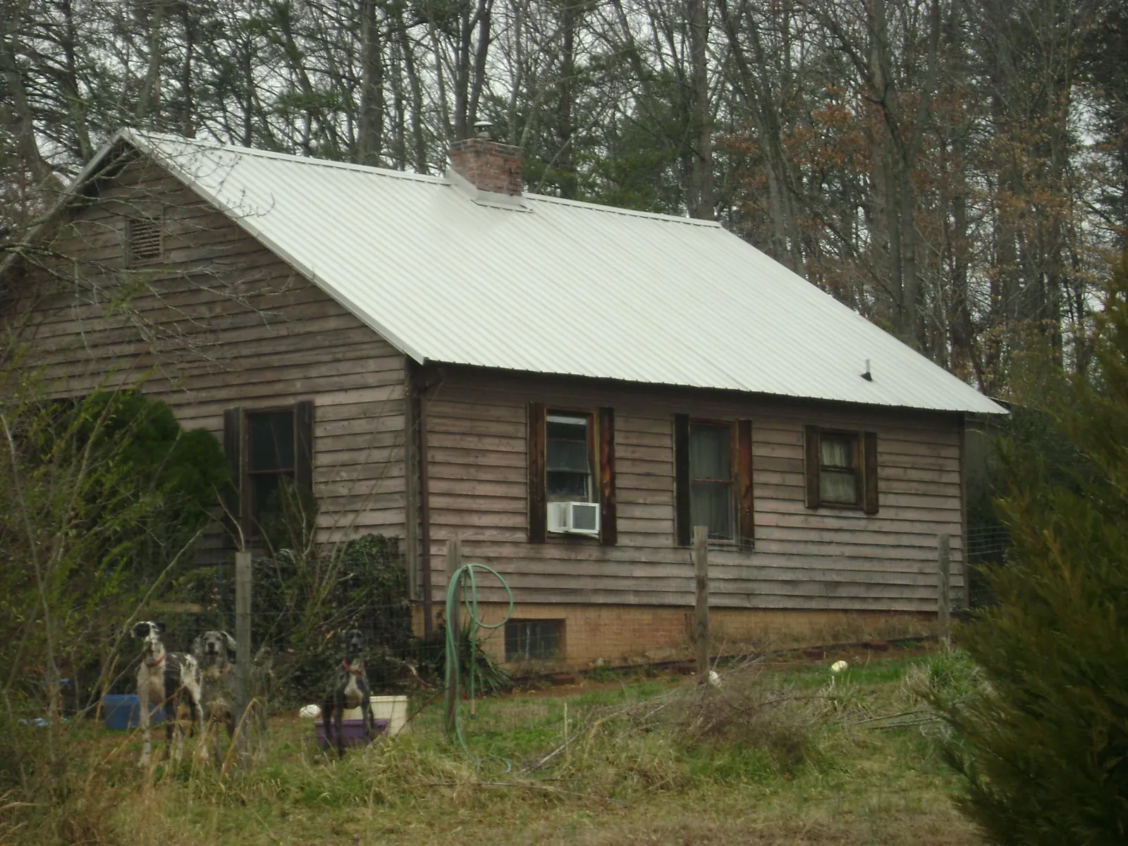 White metal roof on an old wood sided farmhouse, from a Asphalt Shingle Roof Repair job in North Brunswick